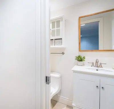 a white bathroom with a sink and a toilet at The Mountain House - Walk to the Village in Blue Mountains