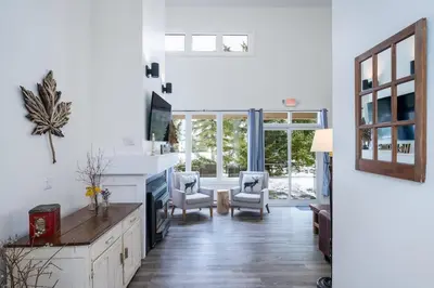 a living room with white walls and a large window at The Mountain House - Walk to the Village in Blue Mountains