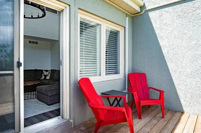 two red chairs and a table on a porch at Apres-Blu - Walk to theVillage - Sleeps 7 in Blue Mountains