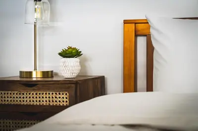 a bedroom with a bed and a table with a lamp at Apres-Blu - Walk to theVillage - Sleeps 7 in Blue Mountains