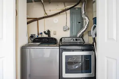 a kitchen with a stove and a washer and dryer at Apres-Blu - Walk to theVillage - Sleeps 7 in Blue Mountains