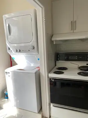 a kitchen with a white refrigerator and a stove at V-Swim Suite-2 in Toronto
