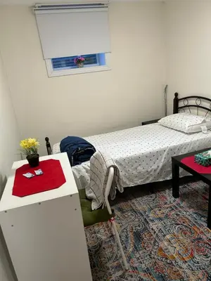 a bedroom with a bed and a desk and a table at V-Swim Suite-3 in Toronto