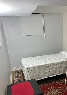 a room with two beds and a red rug at V-Swim Suite-3 in Toronto