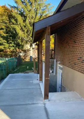 a porch of a brick building with a garage at V-Swim Suite-3 in Toronto