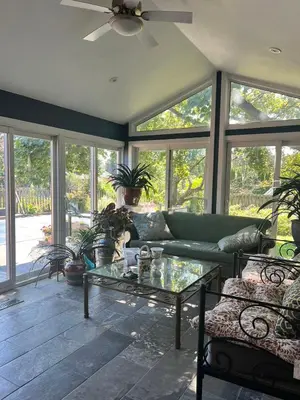 a living room with a couch and a glass table at Grimsby Lakeside Vacation Home in Grimsby