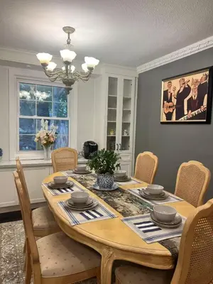 a dining room with a wooden table and chairs at Grimsby Lakeside Vacation Home in Grimsby