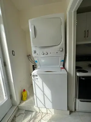 a kitchen with a white refrigerator in a room at V-Swim Suite-1 in Toronto