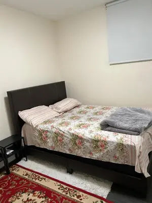 a bedroom with a bed with a blanket on it at V-Swim Suite-1 in Toronto