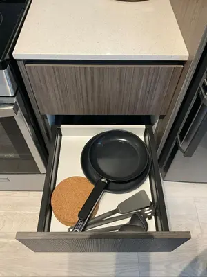 a frying pan and other kitchen utensils in a drawer at Serene Cozy 1BDRM Condo near Sherway Mall, Lakeshore, & Airport in Toronto
