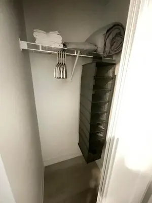 a walk in closet with a shelf and towels at Serene Cozy 1BDRM Condo near Sherway Mall, Lakeshore, & Airport in Toronto
