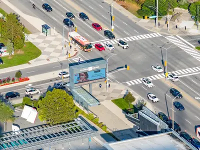 an overhead view of a busy city intersection with traffic at The Grand Aurelia Suites - Mississauga City Center in Mississauga