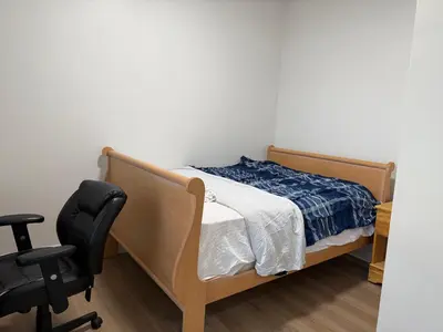 a bedroom with a bed and a desk and a chair at Downtown Residence Room 3 in Guelph