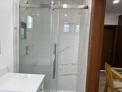 a shower with a glass door in a bathroom at Downtown Residence Room 3 in Guelph