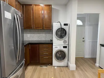 a kitchen with a refrigerator and a washer and dryer at Downtown Residence Room 3 in Guelph