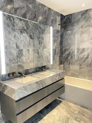a bathroom with a sink and a mirror at Deluxe Suites & Towers Downtown Toronto in Toronto