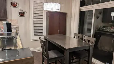 a kitchen with a table and chairs in a kitchen at Bright Bedroom with Shared bathroom and WiFi Parking available in Markham