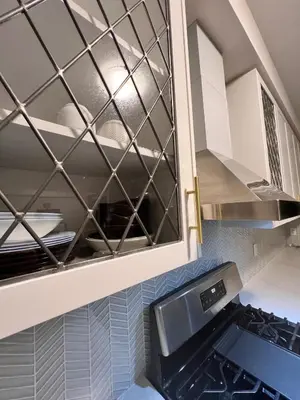 a kitchen with white cabinets and a sink at AyrHaus- Modern Comfort Meets Small-Town Charm