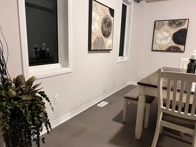 a dining room with a table and two windows at AyrHaus- Modern Comfort Meets Small-Town Charm