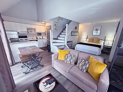 a living room with a couch and a bed at Slopeside Loft at North Creek Resort in Blue Mountains