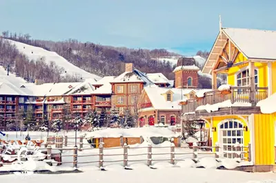 a resort in the snow with snow covered buildings at Slopeside Loft at North Creek Resort in Blue Mountains