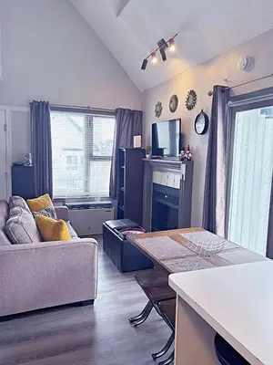 a living room with a couch and a table at Slopeside Loft at North Creek Resort in Blue Mountains