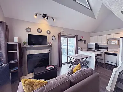 a living room with a couch and a fireplace at Slopeside Loft at North Creek Resort in Blue Mountains