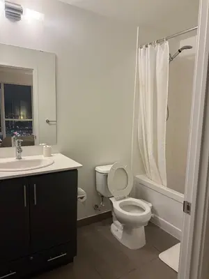 a bathroom with a toilet and a sink at The greatest views in the heart of Mississauga in Mississauga