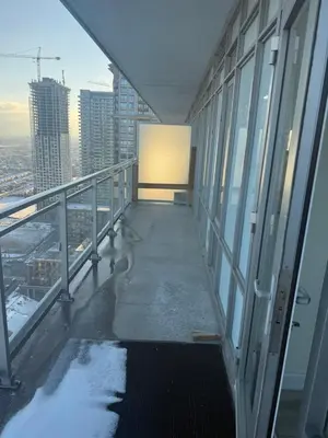 a balcony of a building with snow on the ground at The greatest views in the heart of Mississauga in Mississauga