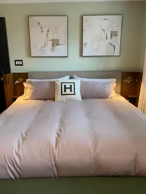 a white bed with two pillows on top of it at Hattan House Boutique Hotel Bed & Breakfast in Niagara on the Lake