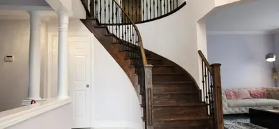 a winding staircase in a home with white walls at Modern Cozy Nook in Brampton