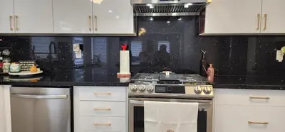a kitchen with a stove and white cabinets at Modern Cozy Nook in Brampton