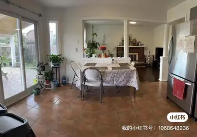 a living room with a table and a refrigerator at M2 Private cozy bedroom in Mississauga