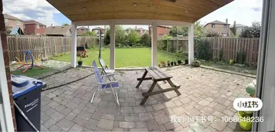 a patio with a picnic table and a chair at M2 Private cozy bedroom in Mississauga