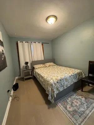 a bedroom with a bed and a window at StayMaple in Toronto
