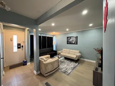 a living room with a couch and a chair at StayMaple in Toronto