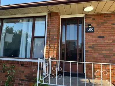 a brick building with a sign on the door at StayMaple in Toronto