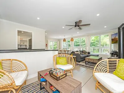 a living room with two chairs and a table at Lakefront Muskoka Cottage with Fire Pit and BBQ in Port Carling