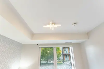 a white ceiling with a chandelier and a window at 1 BR Boutique Charm, Urban Calm! in Oakville