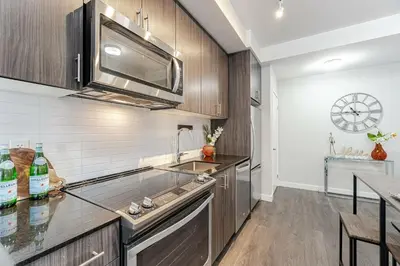 a kitchen with a sink and a microwave at 1 BR Boutique Charm, Urban Calm! in Oakville