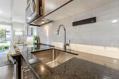 a kitchen with a sink and a counter top at 1 BR Boutique Charm, Urban Calm! in Oakville