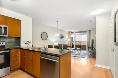 a kitchen with a sink and a stove top oven at High-Rise Skyline Suite Sleeps 5 Steps to SQ1 in Mississauga