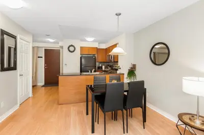 a kitchen and dining room with a table and chairs at High-Rise Skyline Suite Sleeps 5 Steps to SQ1 in Mississauga