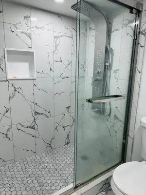 a shower with a glass door in a bathroom at Konia Abode in Orangeville