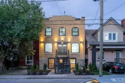 a brick house with lights on the front of it at Renovated Church Hamilton! Evening Event Rental! in Hamilton