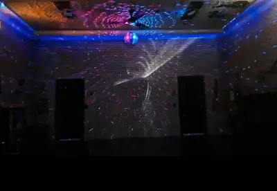 a stage with a light projected on a brick wall at Renovated Church Hamilton! Evening Event Rental! in Hamilton