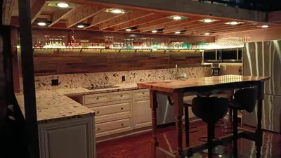 a kitchen with a counter and a bar in it at Renovated Church Hamilton! Evening Event Rental! in Hamilton