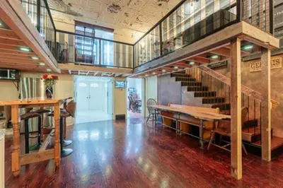 a large room with a staircase and a wooden floor at Renovated Church Hamilton! Evening Event Rental! in Hamilton