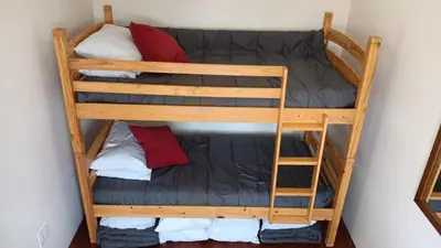 a bunk bed in a room with red pillows at Renovated Church Hamilton! Evening Event Rental! in Hamilton