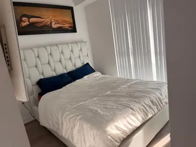 a bedroom with a bed and a painting on the wall at Uniqueplace in Vaughan